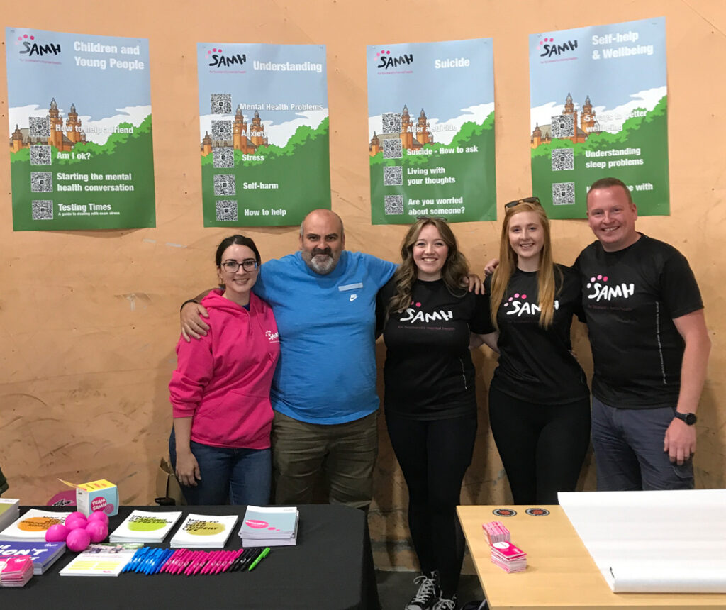 Representatives from The Scottish Association for Mental Health at their information stand at the Why So Sad? Glasgow 2022 event