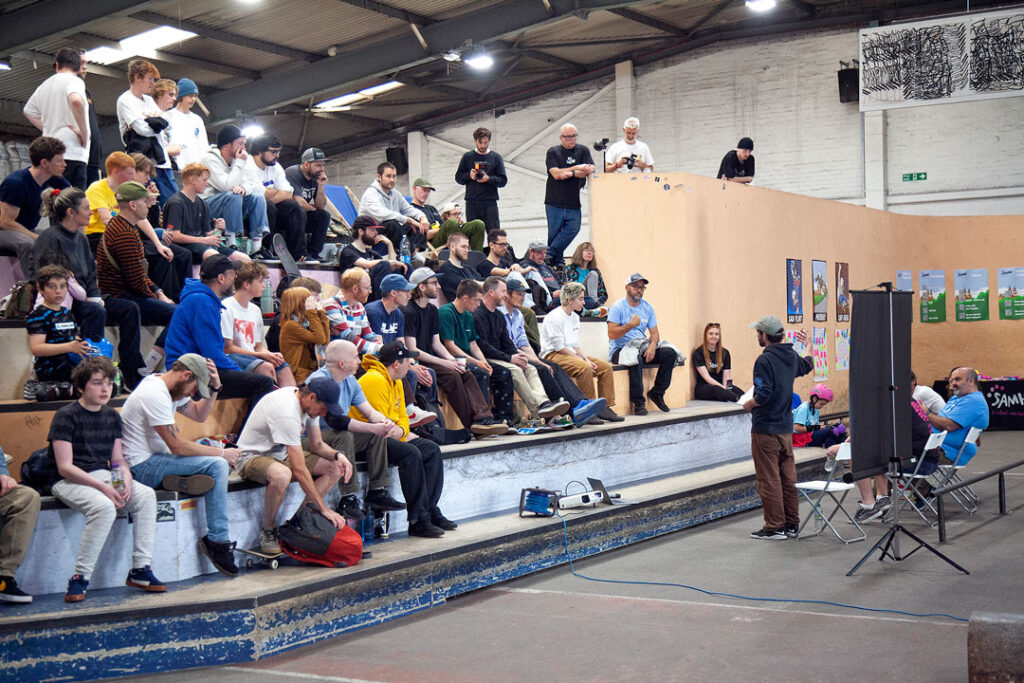 John Rattray addresses the audience at Loading Bay Skatepark, wide shot.